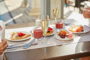 a table with plates of food and glasses of champagne at Hotel Cleopatra Palace in Playa de las Americas