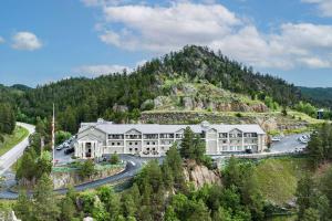 a large building on a mountain with a road at Baymont by Wyndham Keystone Near Mt. Rushmore in Keystone