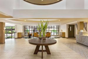 a lobby with a table with flowers on it at Hilton Garden Inn Monterey in Monterey