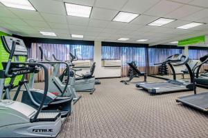 a gym with treadmills and ellipticals in a room at La Quinta by Wyndham New Orleans Airport in Kenner