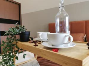 a table with two cups and a bottle on it at Una Serviced Apartment, Jalan Peel in Kuala Lumpur