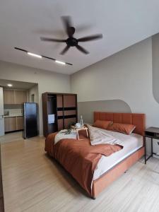 a bedroom with a large bed with a ceiling fan at Una Serviced Apartment, Jalan Peel in Kuala Lumpur
