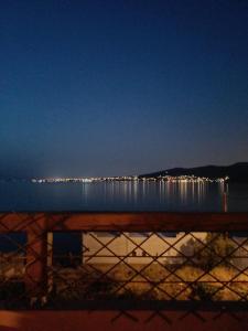 a view of a body of water at night at Calma in Perdika
