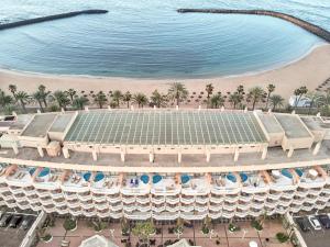 an aerial view of a building with a beach at Hotel Cleopatra Palace in Playa de las Americas