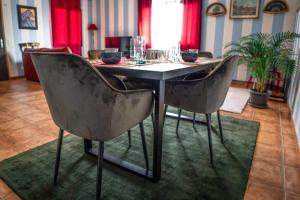 a dining room table with two chairs in a room at Art Apartment Ticino in Vacallo