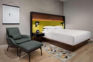 a bedroom with a large bed and a chair at Hyatt Centric Mountain View in Mountain View