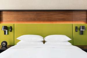 ein Schlafzimmer mit einem weißen Bett und einer grünen Wand in der Unterkunft Hyatt Centric Mountain View in Mountain View
