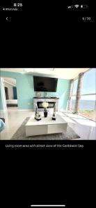 a living room area with direct view of the ocean at Bayfront in Portmore
