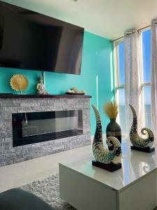 a living room with a fireplace and two vases on a table at Bayfront in Portmore