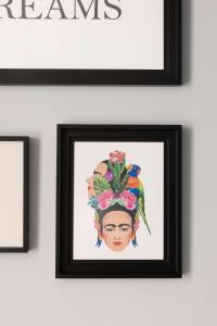 a painting of a woman with a bird on her head at Hampton by Hilton Tours Centre, France in Tours