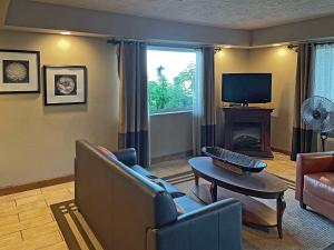 a living room with a couch and a tv at Quality Inn in Clinton