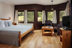 Posteľ alebo postele v izbe v ubytovaní Hotel Zámeček Janovičky