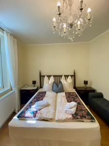 a bedroom with a large bed with a chandelier at Luxus Residenz Königstein in Königstein im Taunus