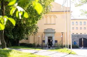 a building with a tree in front of it at Långholmen Hotell in Stockholm