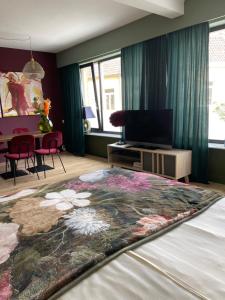 a bedroom with a bed with a flower rug on it at Castle View 2 in Valkenburg