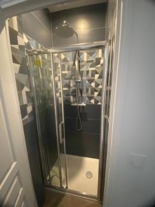 a shower with a glass door in a bathroom at Rooftop vue sur le stade de France in Saint-Denis