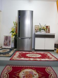 a kitchen with a refrigerator and two rugs at little heritage home in George Town +37 photos