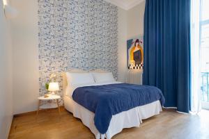 a bedroom with a bed and a blue curtain at B&B Donna Adelina in Naples