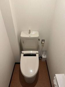 a bathroom with a white toilet in a room at アンドステイ中野弥生町 in Tokyo