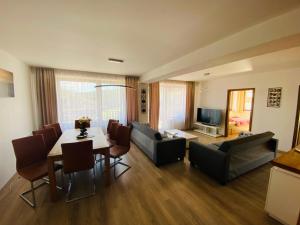 a living room with a table and a dining room at Apartmán Donovaly, Panorama in Donovaly