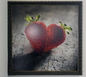 a picture of a heart shaped strawberry on a table at Ribo Apartments in Angri