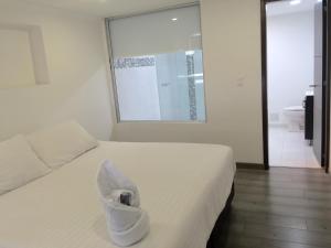 Postel nebo postele na pokoji v ubytování Hotel Metro 26
