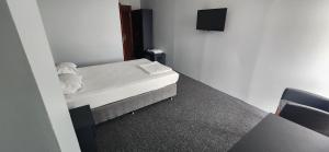a small room with a bed and a tv at BEST HOTEL BURSA in Bursa