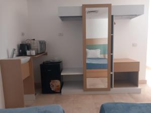 a small bedroom with a bunk bed and a mirror at Nayah Stays, Ground terraces Studio in Hurghada