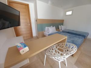 a small room with a table and a bed at Nayah Stays, Ground terraces Studio in Hurghada