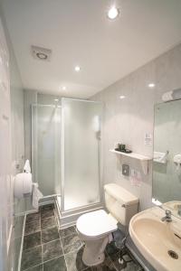 a bathroom with a shower and a toilet and a sink at Can-Y-Bae Hotel in Llandudno