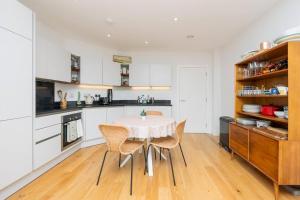 a kitchen with a table and chairs in a room at Cosy 2 bed flat in central Bristol on river Avon in Bristol