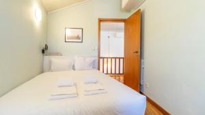 - une chambre avec un lit blanc et 2 serviettes dans l'établissement Pelames 51 by LovelyStay, à Porto