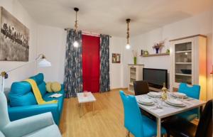 salon ze stołem i niebieskimi krzesłami w obiekcie Apartment Near Picasso Museum w Maladze