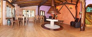 a living room with wooden floors and a table and chairs at Posada Peñas Arriba in Lon