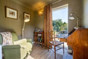 a living room with a desk and a chair and a window at 3 The Mews in York