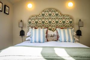 a bedroom with a large bed with a large headboard at 3 The Mews in York
