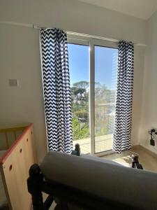 a bedroom with a bed and a large window at Loft with Garden 4 min to Beach in Kyrenia in Kyrenia