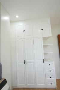 a white closet with white cabinets and a drawer at Luxurious Place Mountain View Spacious with WIFI Parking in Lucena