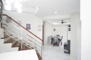 a dining room with a staircase and a table at Luxurious Place Mountain View Spacious with WIFI Parking in Lucena