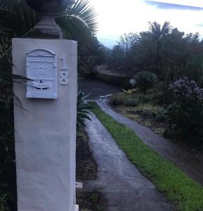 a stone mailbox next to a path in a yard at Casas La Principal in San Pedro