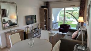 a living room with a couch and a table at LM Résidence in Saint-Tropez