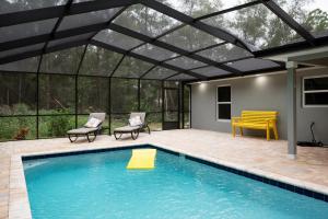 a swimming pool with a pergola and a patio at Pet-friendly, Heated Pool, Close to Everything 3 Bedroom Home in Dunnellon