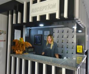 a woman standing behind a counter in a store at La Rezidans Hotel in Antalya