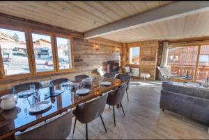 a dining room with a long table and chairs at Chalet 2 sur la route du tour in LʼHuez