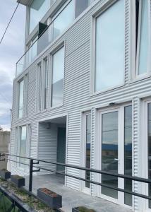 an exterior view of a building with large windows at Miras Apartment Ushuaia in Ushuaia