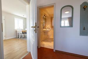 a hallway with a door leading to a bathroom at Haus Amanda in Norddorf +214 photos