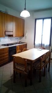 cocina con mesa y sillas y cocina con fogones en CASA MAMMA, en Camponogara