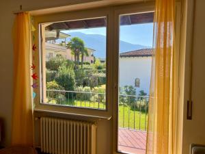 a window with a view of a house at Ascona Casa Farfalla 1 in Ascona
