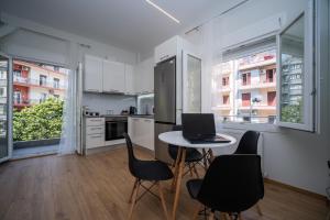 een keuken met een tafel met stoelen en een laptop erop bij Agias Sofias Svolou Center 2 in Thessaloniki