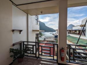 a balcony with a view of the water at Devayn's Inn in El Nido